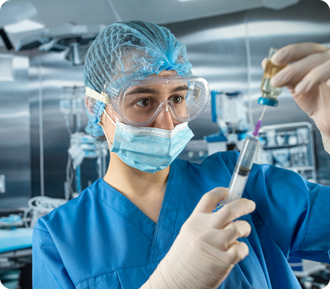 Healthcare worker handling a syringe carefully
