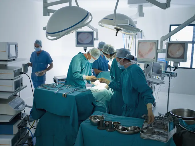 Surgical team working in an operating room during surgery.